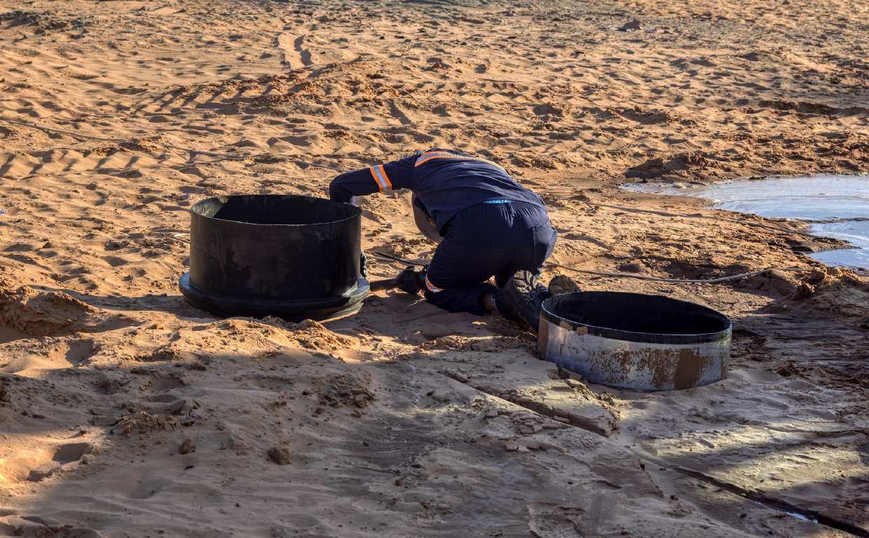 Septic Inspection in Kingston, NY — Inspector opening two septic tank access lids for inspection