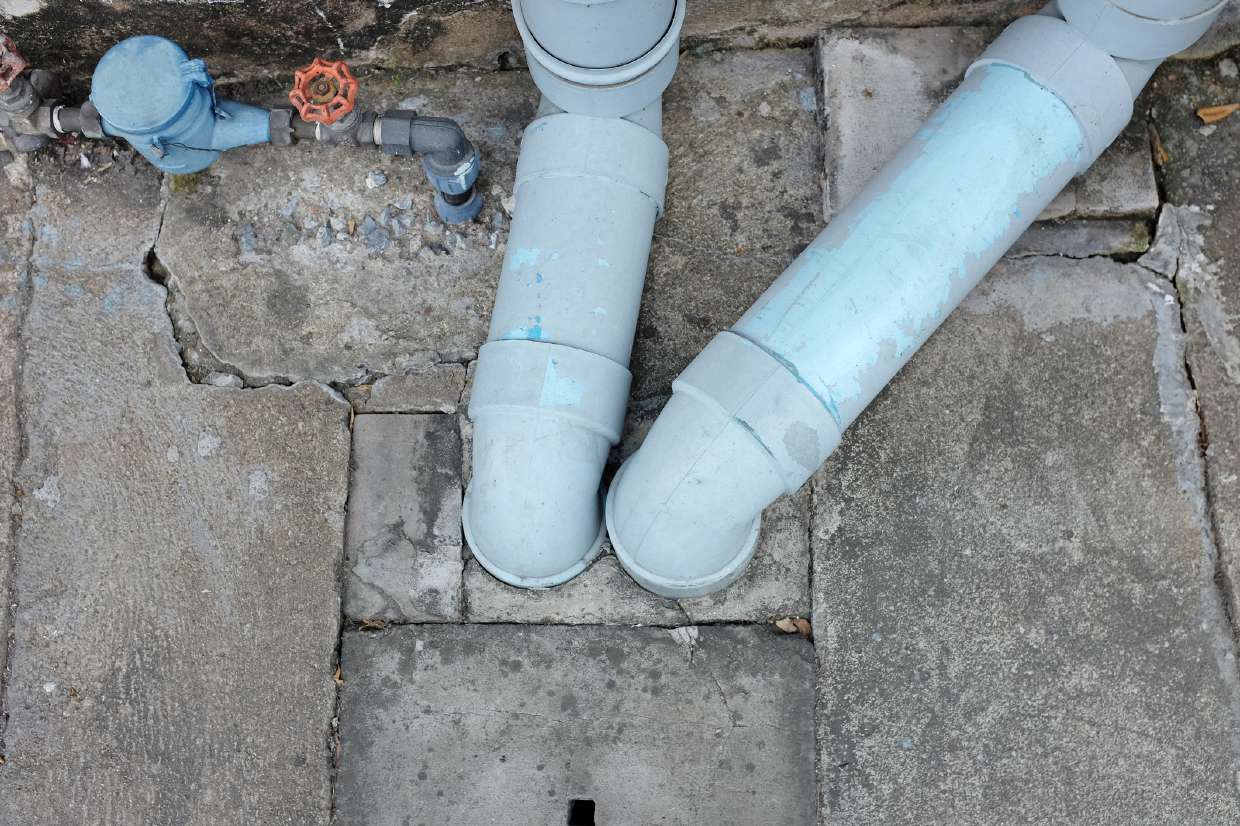 Septic and drain piping connections at a tank access point