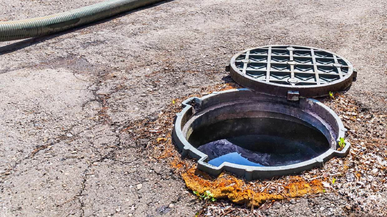 Sewer Camera Inspection in Kingston, NY — Open sewer manhole on a paved surface