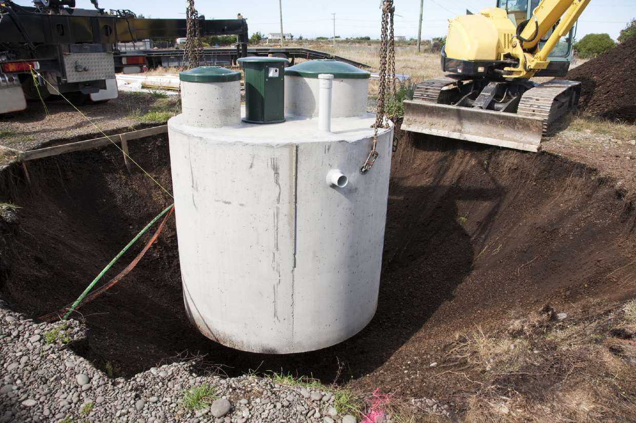 Septic Repair in Kingston, NY — Concrete septic tank being lowered into an excavation