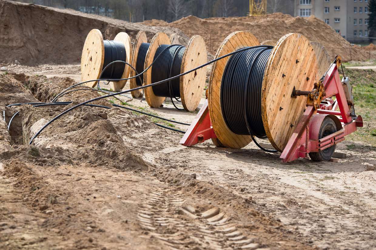 Sewer Snaking / Roto-Rooter project in New Paltz, NY — Conduit and pipe reels staged at a site excavation