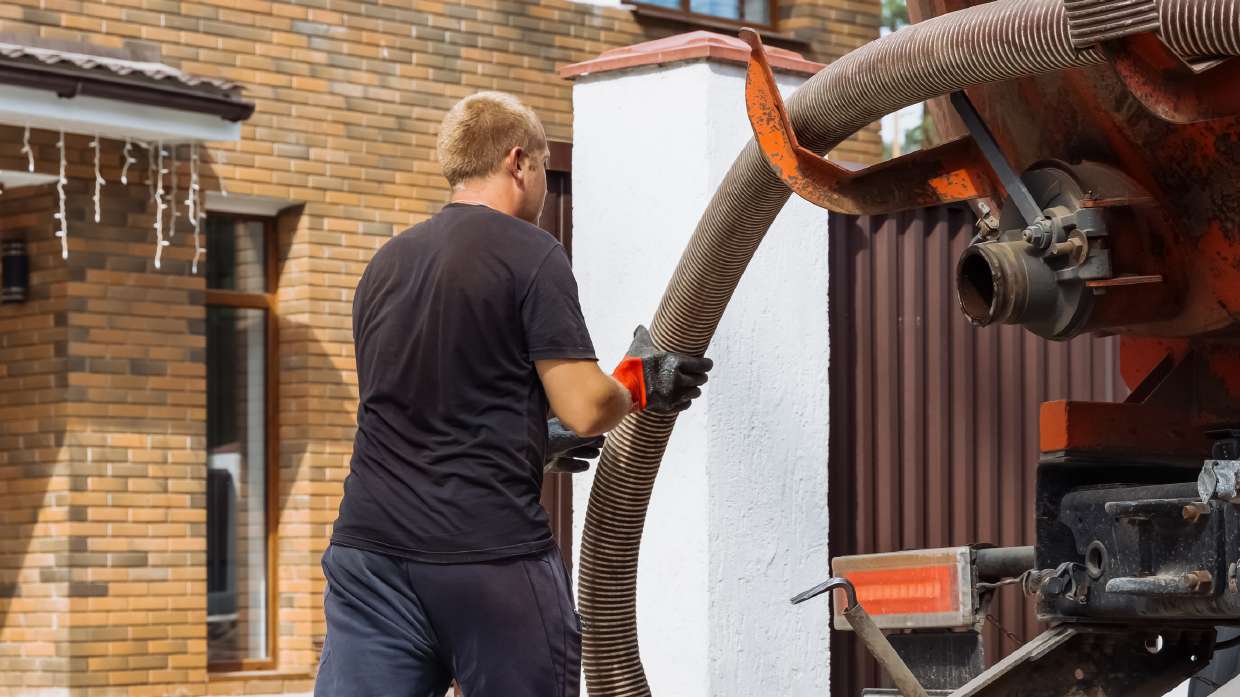 Technician running a hose line at a house connection in New Paltz, NY