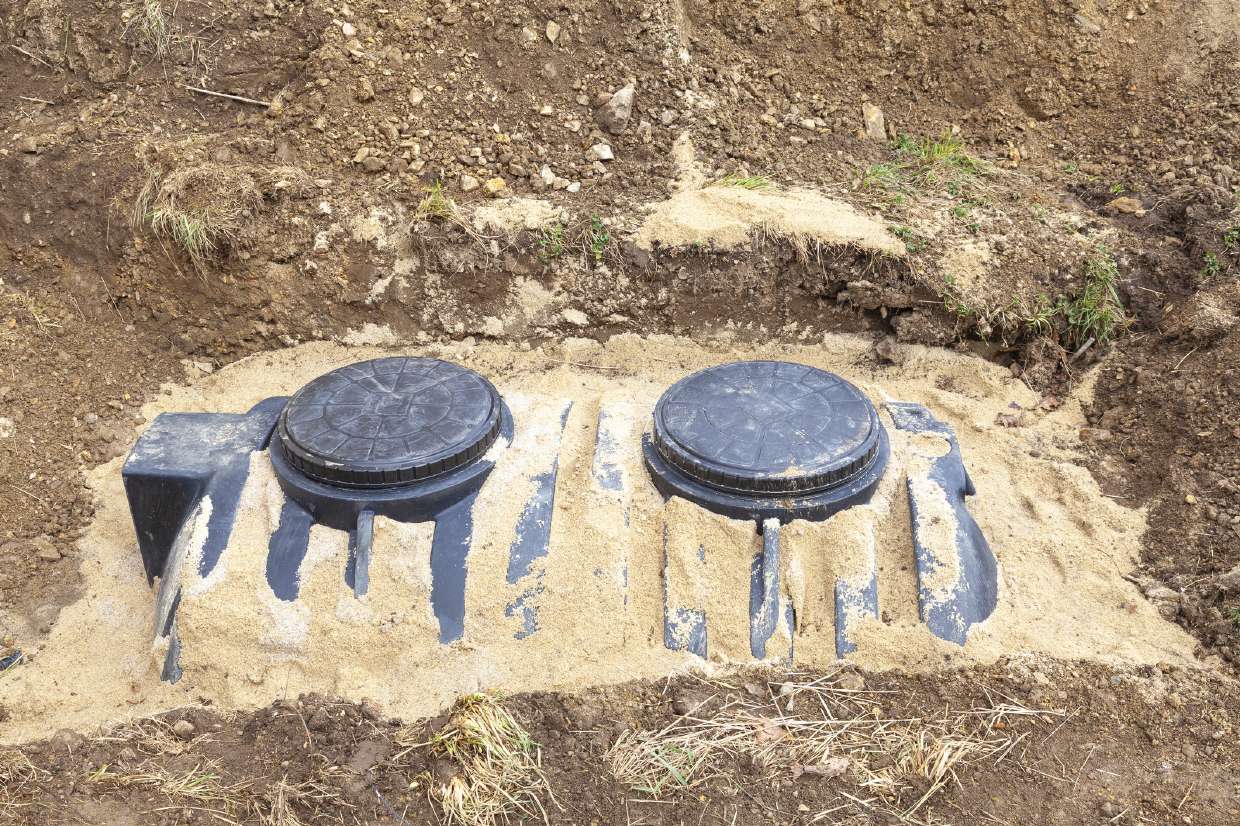 Two septic access lids set in a sand bed in Hurley, NY