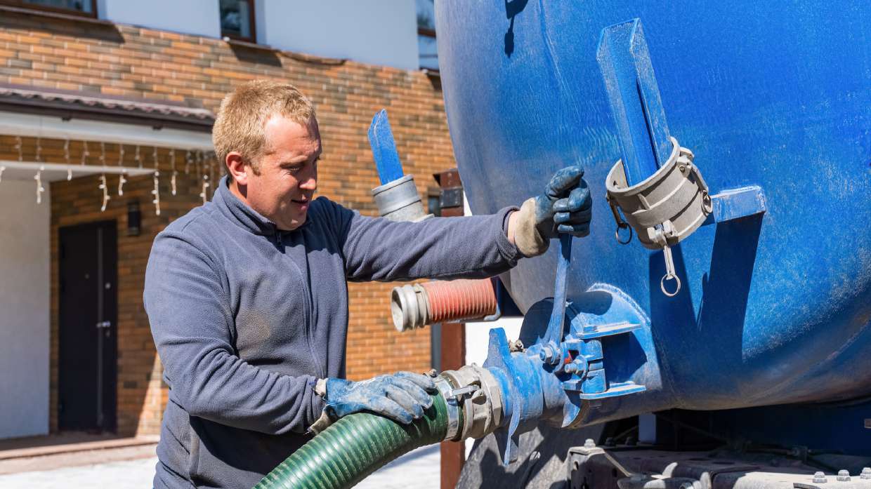 Sewer Snaking / Roto-Rooter Service in Kingston, NY — Technician connecting the discharge line on a service tank