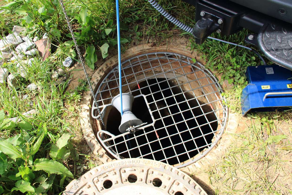 Septic Tank & Leach Field Locating/Mapping in Kingston, NY — Grated septic access cover set in a grassy yard