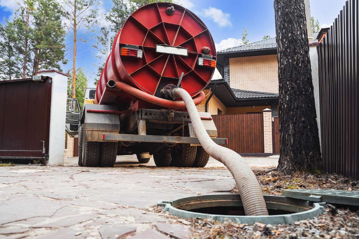 Septic service truck with hose reel pumping a tank in Woodstock, NY