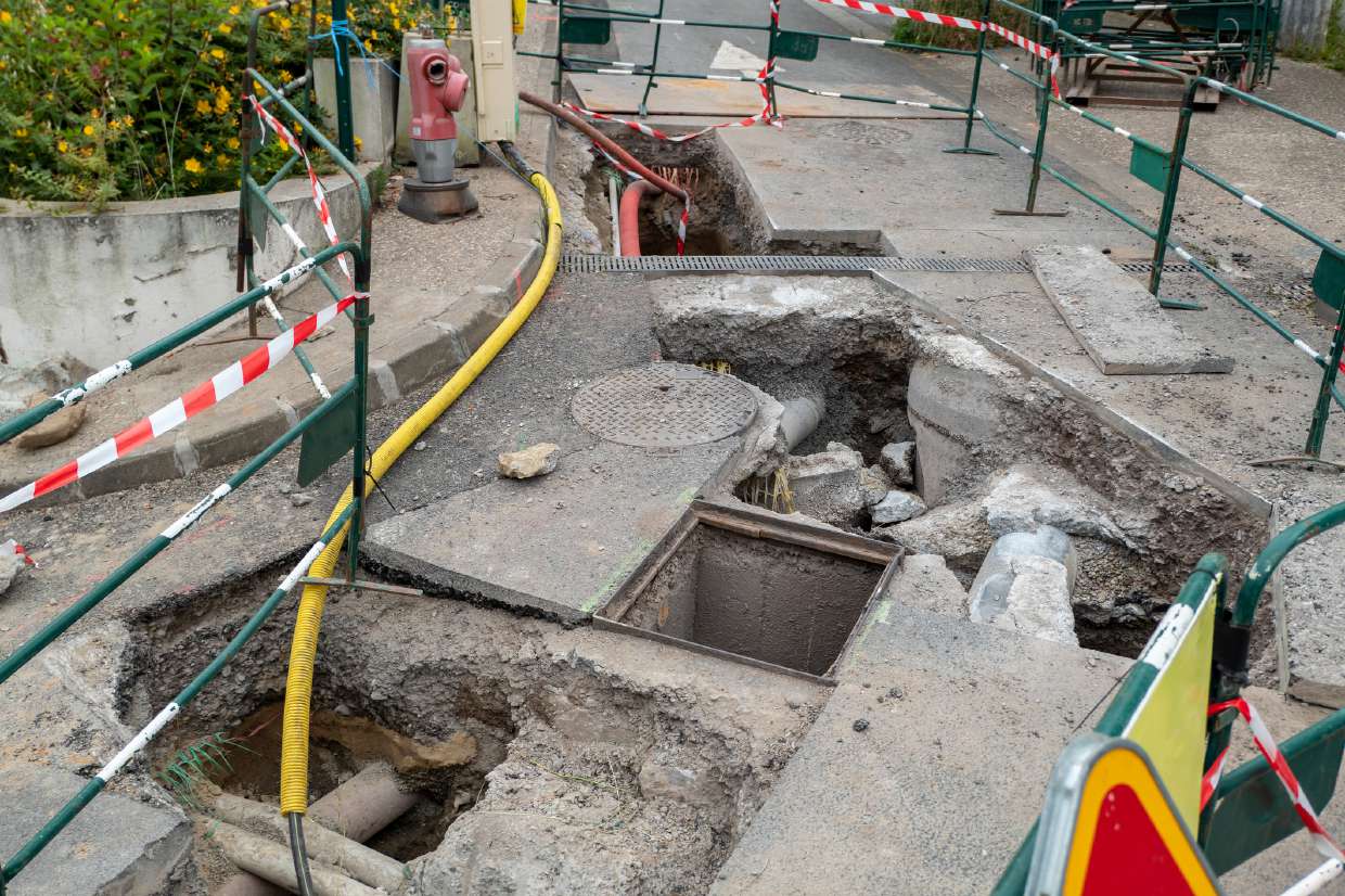 Septic Inspection project in Kingston, NY — Excavated street section exposing sewer structures